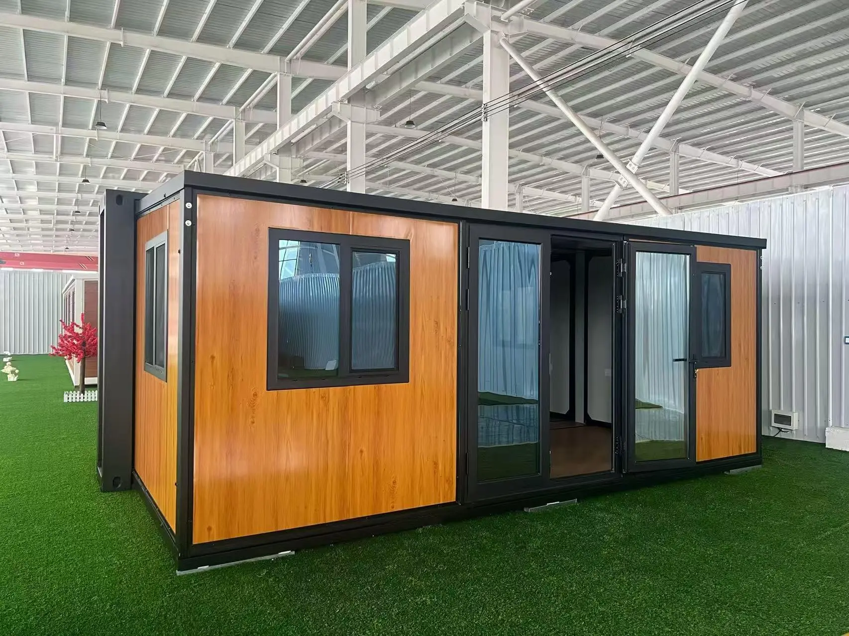 Expandable prefab home displayed inside a factory showroom